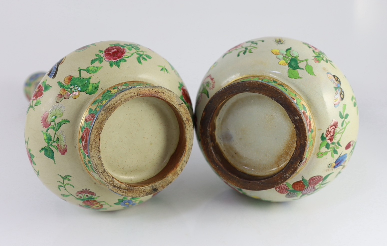 A pair of Chinese enamelled porcelain crackle glaze bottle vases, mid 19th century, 33cm high, chips to feet